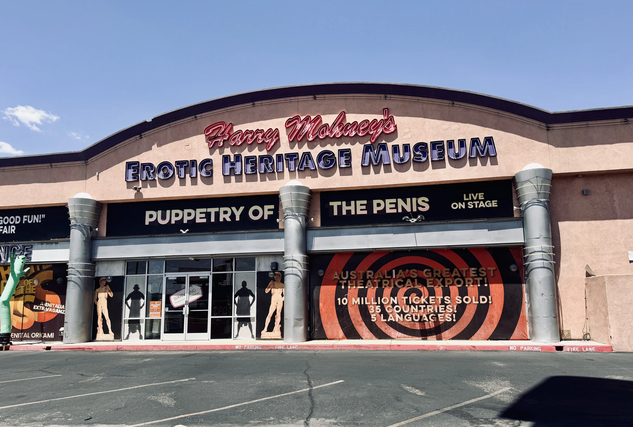 The pink stucco frontage of Harry Mohney's Erotic Heritage Museum, advertising Puppetry of the Penis live on stage.