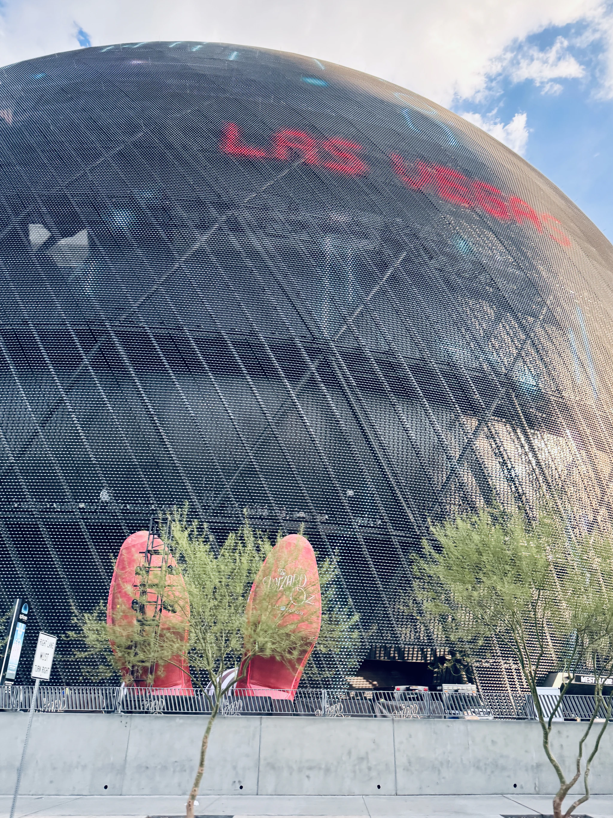 The Sphere seen from below, its dark faceted exterior lit with the words LAS VEGAS.