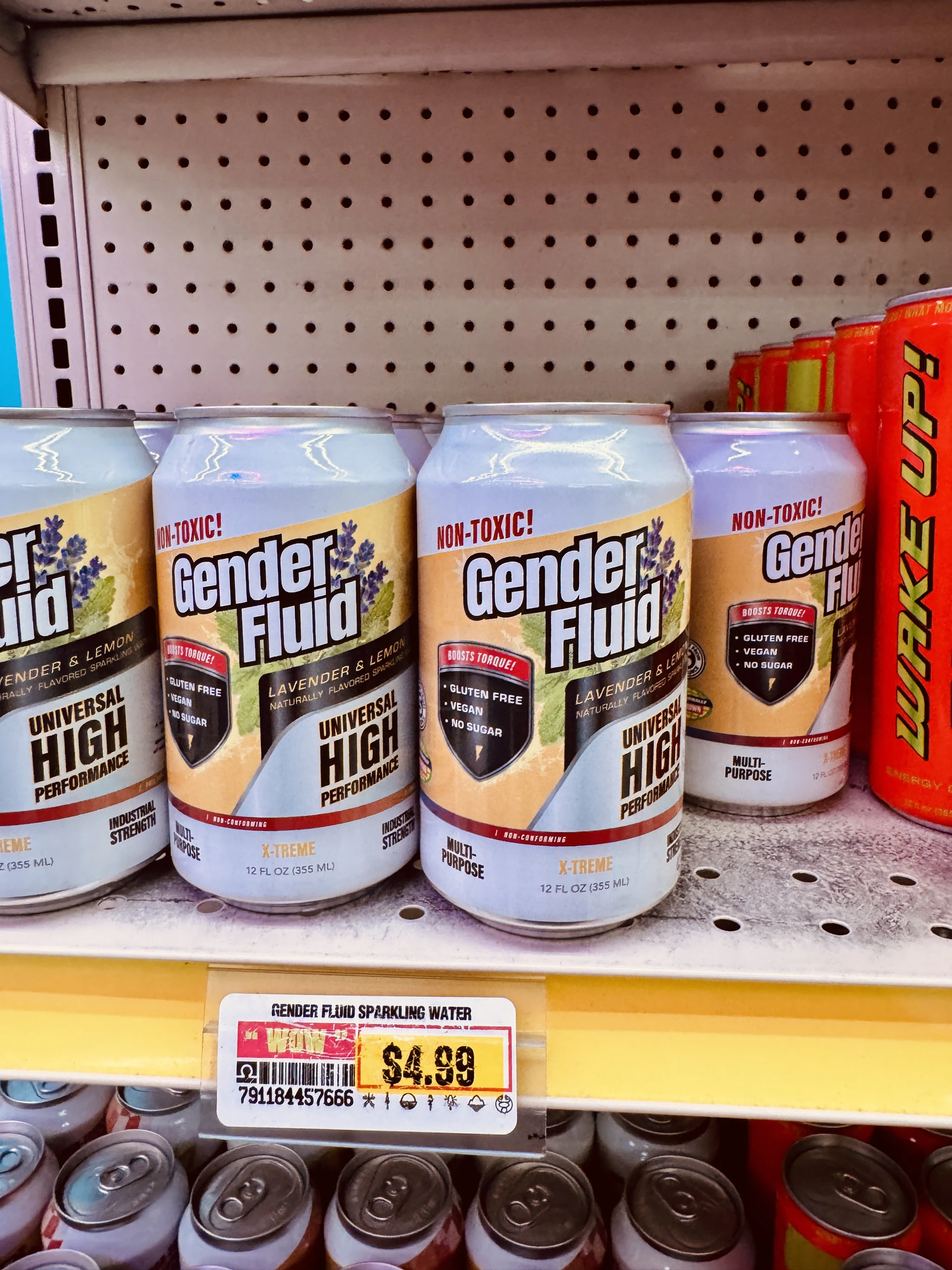 Cans of Gender Fluid lavender and lemon sparkling water on an Omega Mart shelf, priced $4.99.